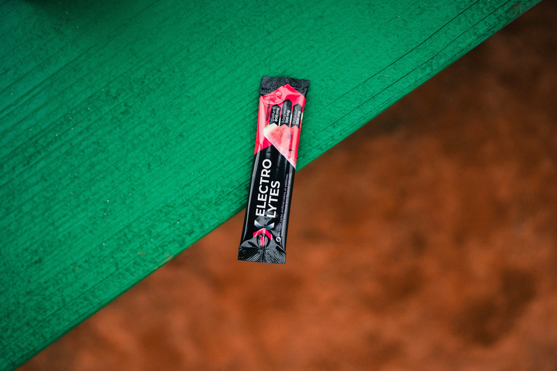 COR-X X-Electrolytes sachet on a green surface representing hydration and performance support.